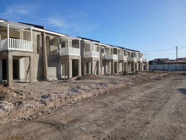 Row of housing units and site access — HAJ Housing Development, 3 North, Portmore, St. Catherine
