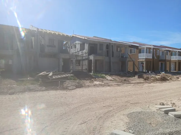 Housing units along the construction access route — HAJ Housing Development, 3 North, Portmore, St. Catherine