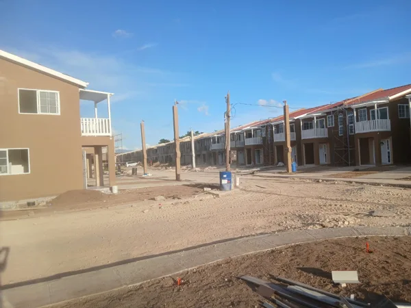 Painted façades with ongoing site works — HAJ Housing Development, 3 North, Portmore, St. Catherine