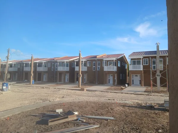 Row of housing units with painted finishes — HAJ Housing Development, 3 North, Portmore, St. Catherine