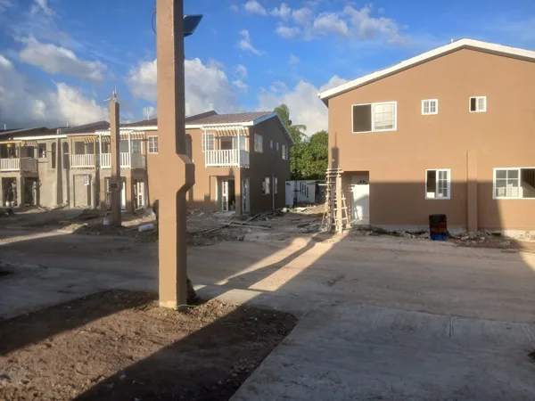 Painted building elevations and site access — HAJ Housing Development, 3 North, Portmore, St. Catherine